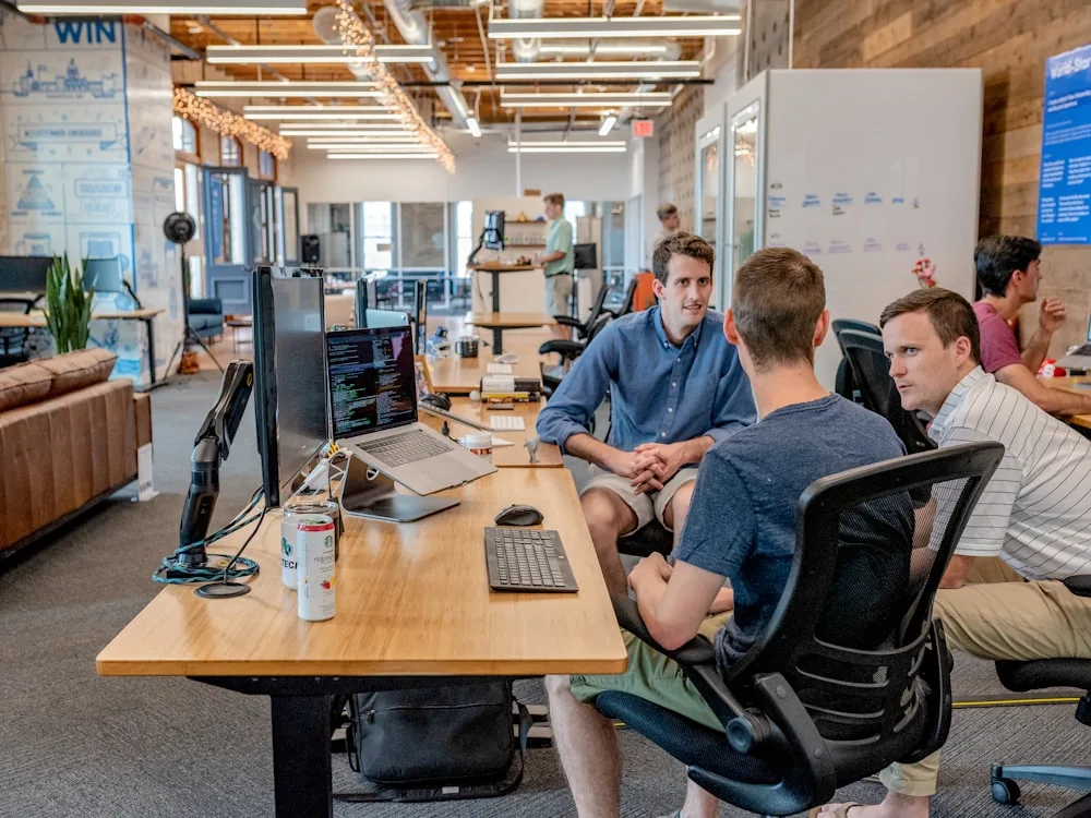 People working together around a shared desk